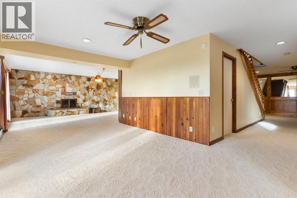 39 Coach Gate Way Sw, Calgary, AB - Indoor Photo Showing Other Room With Fireplace