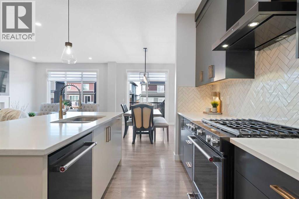 96 Emberside Glen, Cochrane, AB - Indoor Photo Showing Kitchen With Stainless Steel Kitchen With Double Sink With Upgraded Kitchen