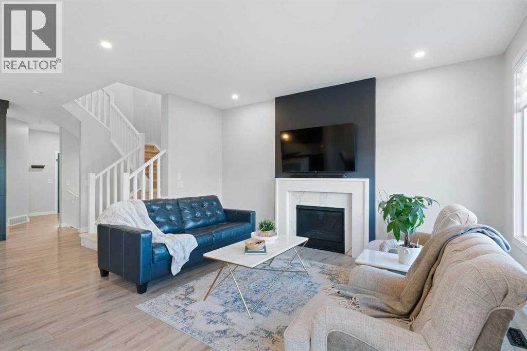 96 Emberside Glen, Cochrane, AB - Indoor Photo Showing Living Room With Fireplace