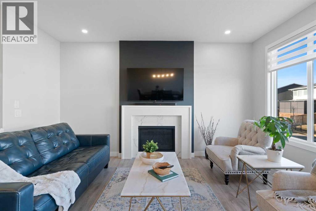 96 Emberside Glen, Cochrane, AB - Indoor Photo Showing Living Room With Fireplace