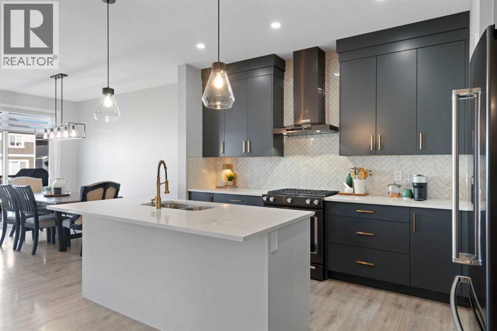 96 Emberside Glen, Cochrane, AB - Indoor Photo Showing Kitchen With Stainless Steel Kitchen With Double Sink With Upgraded Kitchen