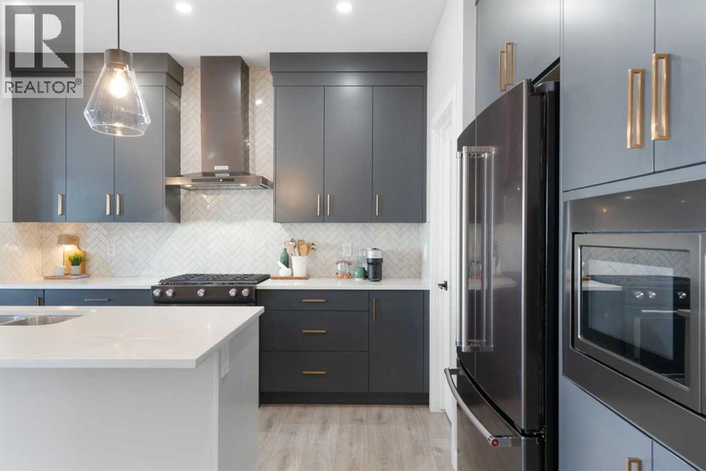 96 Emberside Glen, Cochrane, AB - Indoor Photo Showing Kitchen With Stainless Steel Kitchen With Upgraded Kitchen