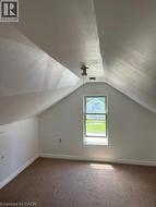 upstairs,featuring sloped ceilings,carpeted flooring -