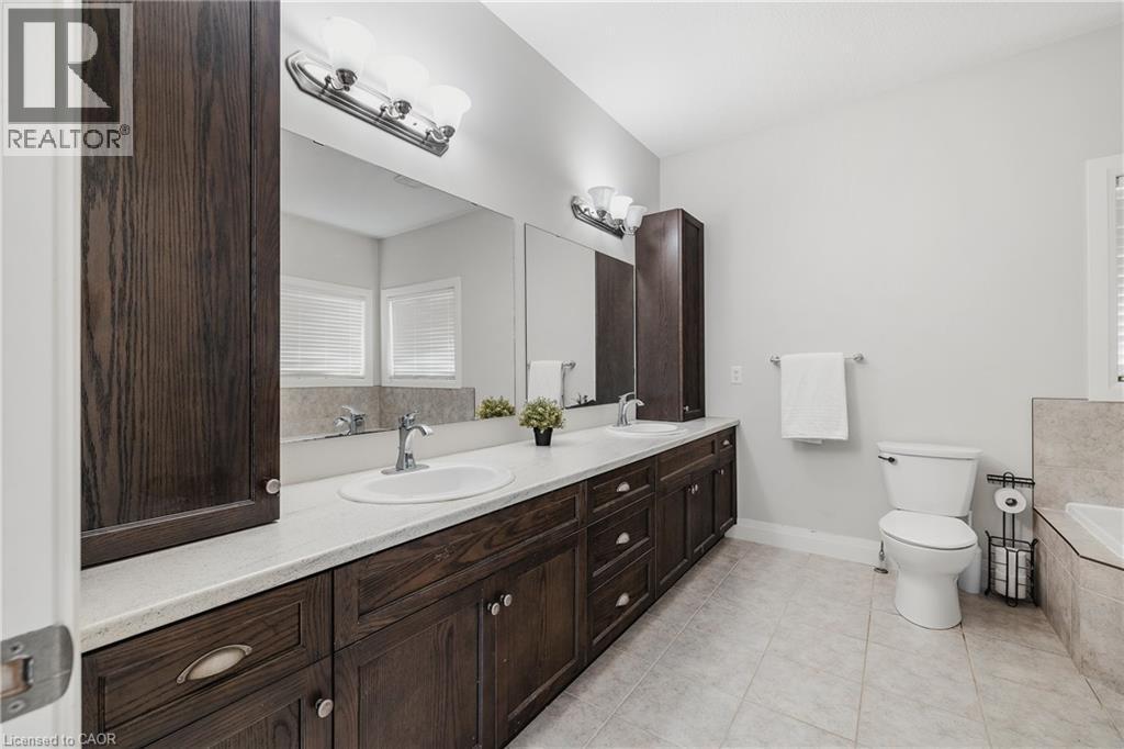 Full bathroom with double vanity, a bath, and light tile patterned floors - 346 Moorlands Crescent, Kitchener, ON - Indoor Photo Showing Bathroom
