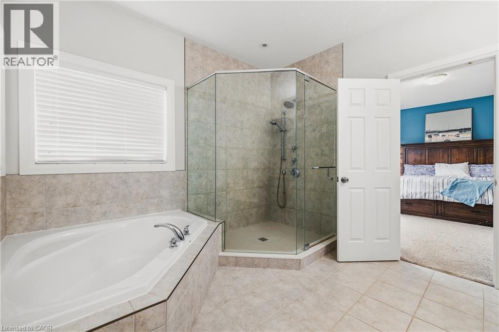 Bathroom with a stall shower, light tile patterned floors, a garden tub, ensuite bathroom, and light carpet - 346 Moorlands Crescent, Kitchener, ON - Indoor Photo Showing Bathroom