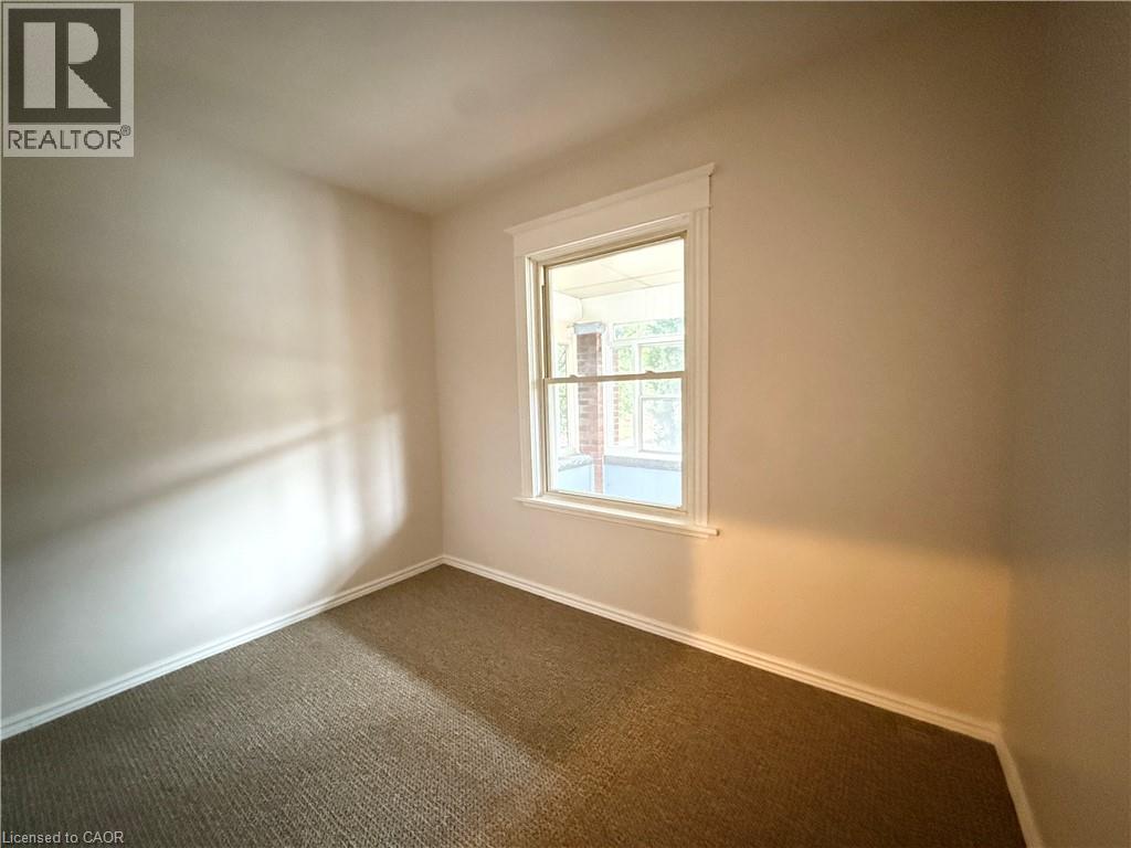 Carpeted empty room featuring baseboards - 24 Somerset Avenue, Hamilton, ON - Indoor Photo Showing Other Room