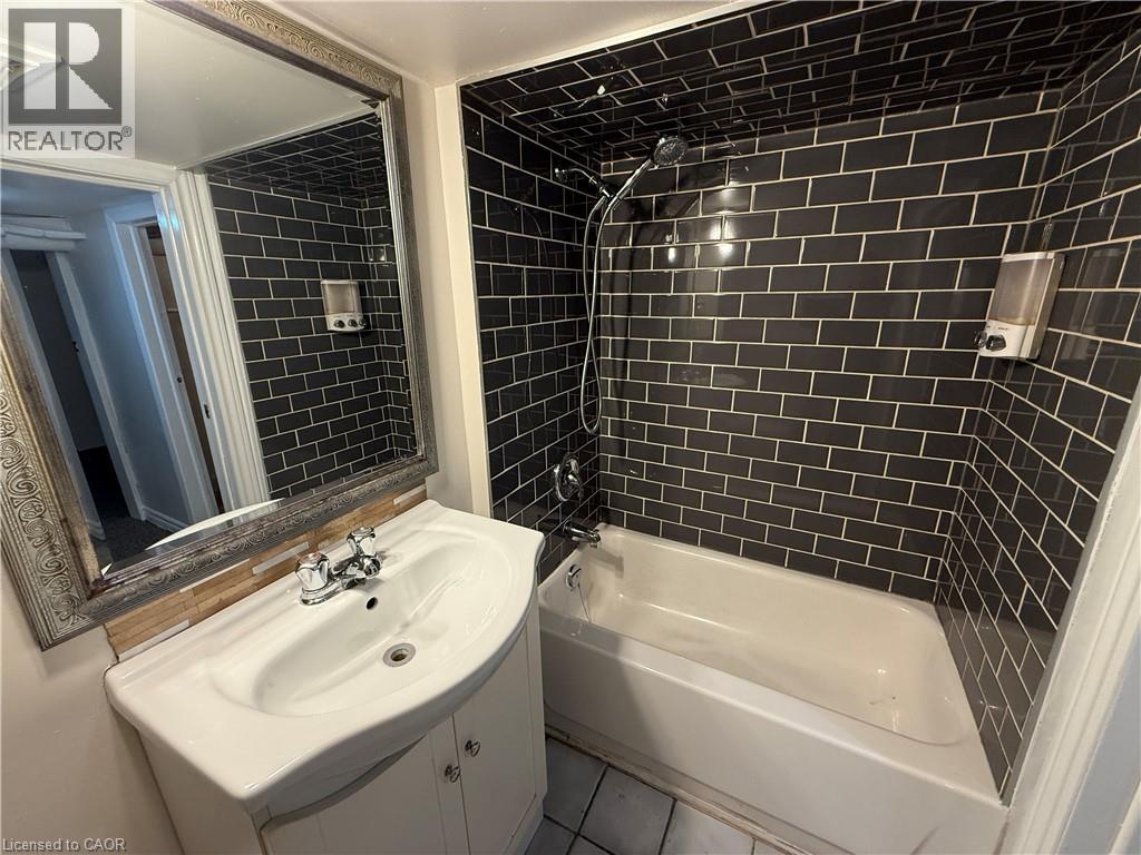 Full bath with vanity, shower / bathtub combination, and tile patterned floors - 24 Somerset Avenue, Hamilton, ON - Indoor Photo Showing Bathroom