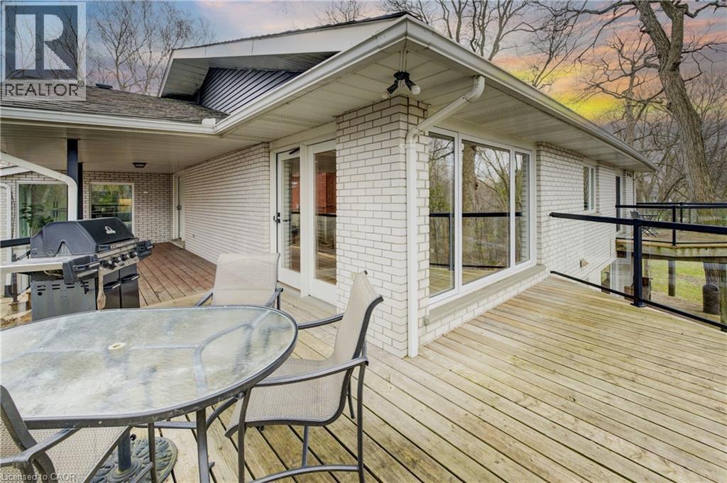 Deck at dusk featuring outdoor dining space and area for grilling - 279 Ferndale Place, Waterloo, ON - Outdoor
