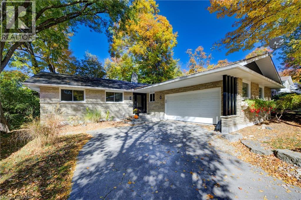 Ranch-style house with brick siding, driveway, a chimney, and an attached garage - 279 Ferndale Place, Waterloo, ON - Outdoor