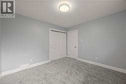 Unfurnished bedroom with carpet flooring and a closet -