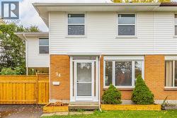 Rear view of property with brick siding and entry steps -