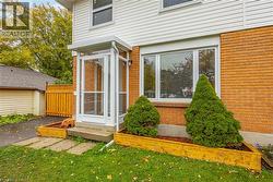 Entrance to property with brick siding and a lawn -