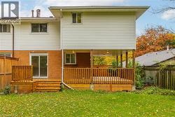 Rear view of house with a fenced backyard and brick siding -