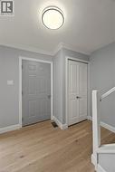 Entrance foyer featuring light wood-type flooring and crown molding -
