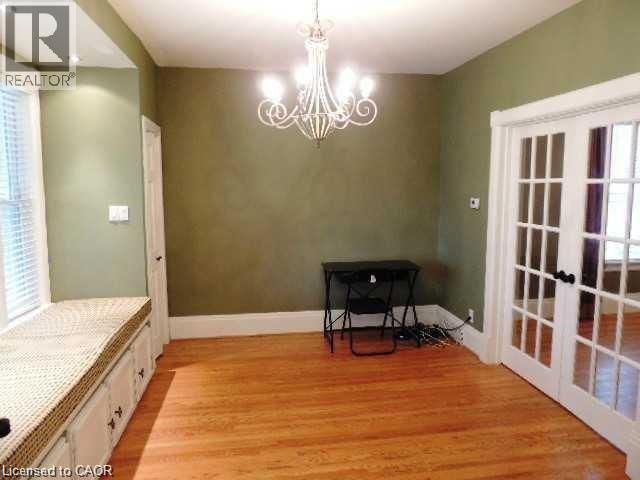 Dining room featuring light wood finished floors, a chandelier, and french doors - 134 Courtland Avenue E, Kitchener, ON