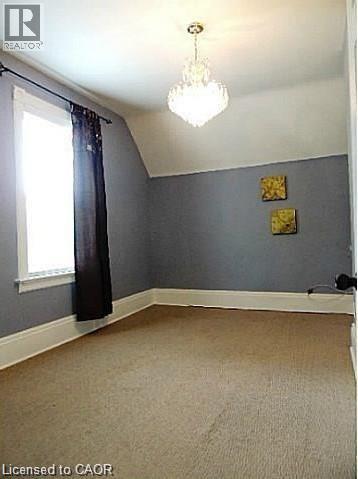 Additional living space with lofted ceiling and light carpet - 134 Courtland Avenue E, Kitchener, ON