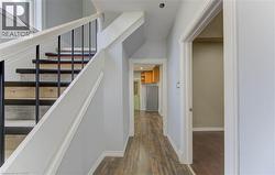 Staircase with wood finished floors and baseboards -