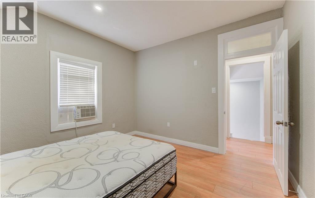 Bedroom with light wood-type flooring and recessed lighting - 138 Courtland Avenue E, Kitchener, ON