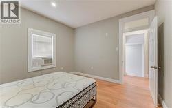 Bedroom with light wood-type flooring and recessed lighting -