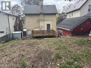 Back of property featuring a deck, a chimney, and an outdoor structure - 138 Courtland Avenue E, Kitchener, ON