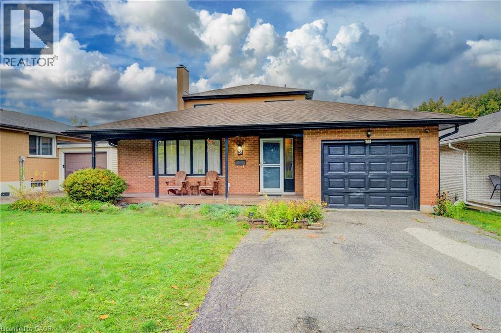 View of front of property featuring a garage, roof with shingles, asphalt driveway, a front yard, and a chimney - 31 Bonfair Court, Kitchener, ON - Outdoor