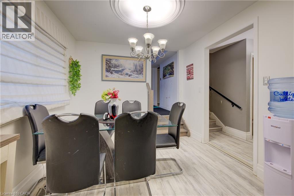 Dining room with light wood-type flooring, a chandelier, and stairs - 31 Bonfair Court, Kitchener, ON - Indoor