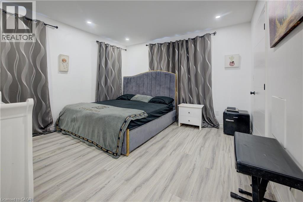 Bedroom with wood finished floors and recessed lighting - 31 Bonfair Court, Kitchener, ON - Indoor Photo Showing Bedroom