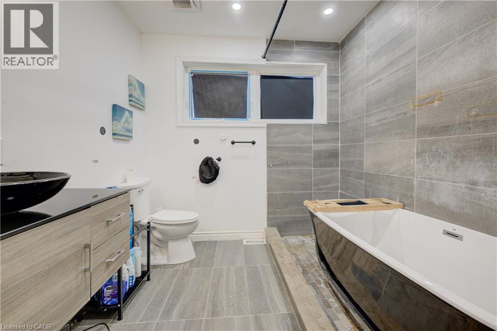 Bathroom with vanity, a garden tub, recessed lighting, tile walls, and walk in shower - 31 Bonfair Court, Kitchener, ON - Indoor Photo Showing Bathroom