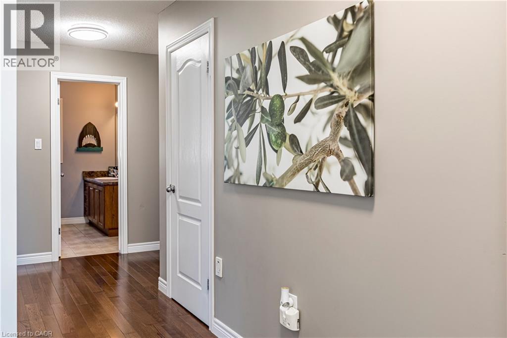 Corridor with a textured ceiling and dark wood-style flooring - 28 Springbreeze Heights, Hamilton, ON - Indoor Photo Showing Other Room