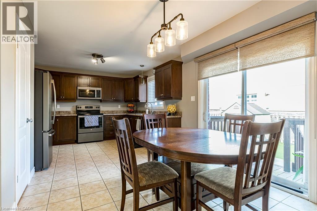 Dining area featuring light tile patterned flooring - 28 Springbreeze Heights, Hamilton, ON - Indoor Photo Showing Dining Room