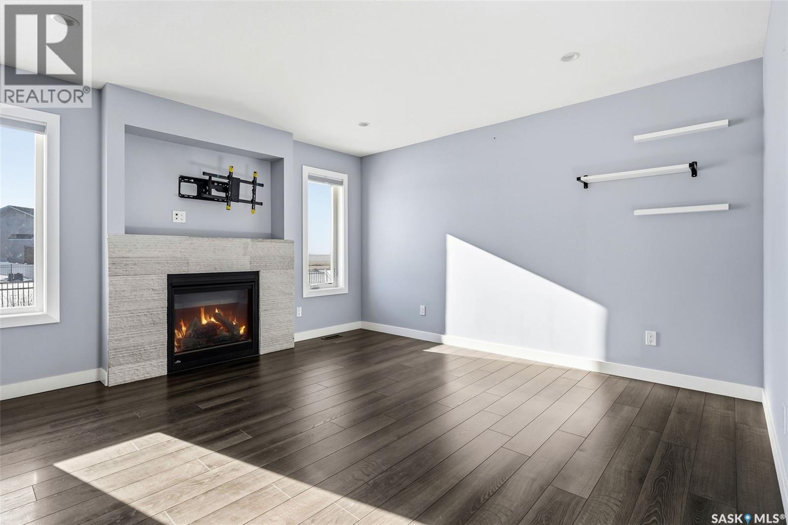 5669 Glide Crescent, Regina, SK - Indoor Photo Showing Living Room With Fireplace