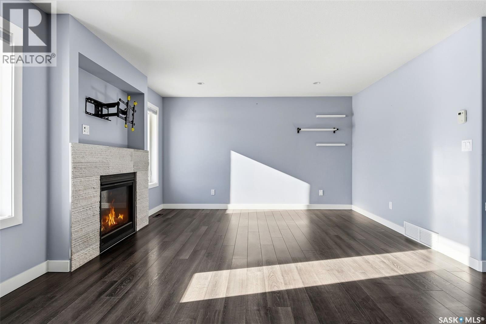 5669 Glide Crescent, Regina, SK - Indoor With Fireplace