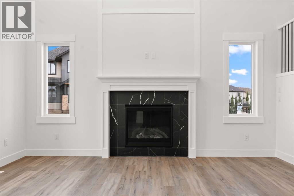 Picture is from a recent build by the builder with similar finishes and will be similar but not an exact match - 53 Heritage Park, Cochrane, AB - Indoor Photo Showing Living Room With Fireplace