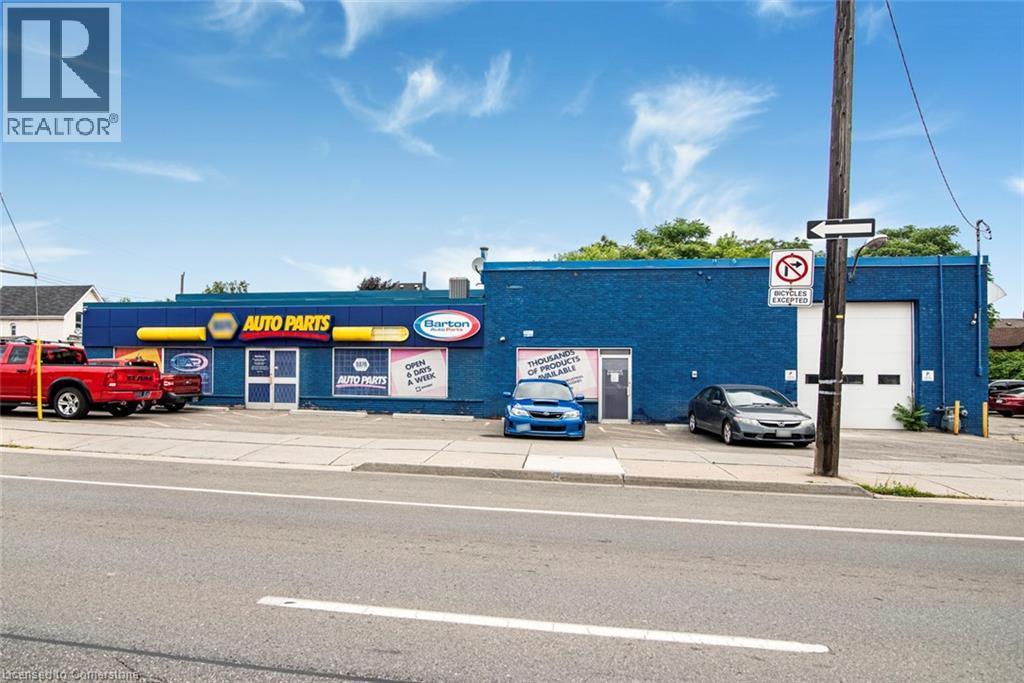 View of commercial property featuring uncovered parking - 361 Cannon Street E, Hamilton, ON