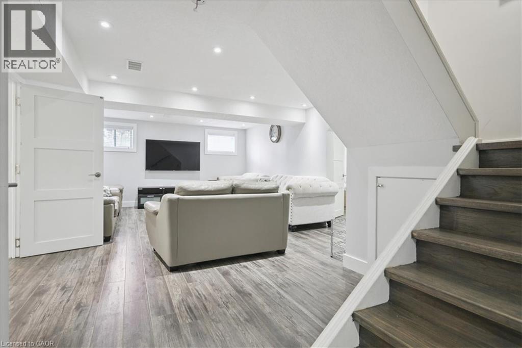 Living room with stairs, light wood finished floors, and recessed lighting - 629 Burning Bush Road, Waterloo, ON - Indoor Photo Showing Other Room