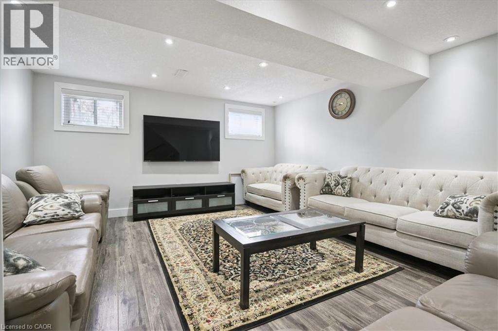 Living room with wood finished floors and recessed lighting - 629 Burning Bush Road, Waterloo, ON - Indoor Photo Showing Living Room