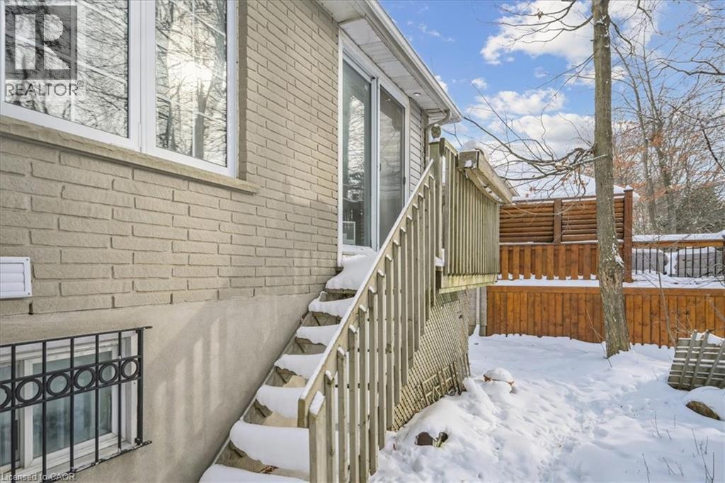View of snow covered exterior featuring brick siding - 629 Burning Bush Road, Waterloo, ON - Outdoor With Exterior