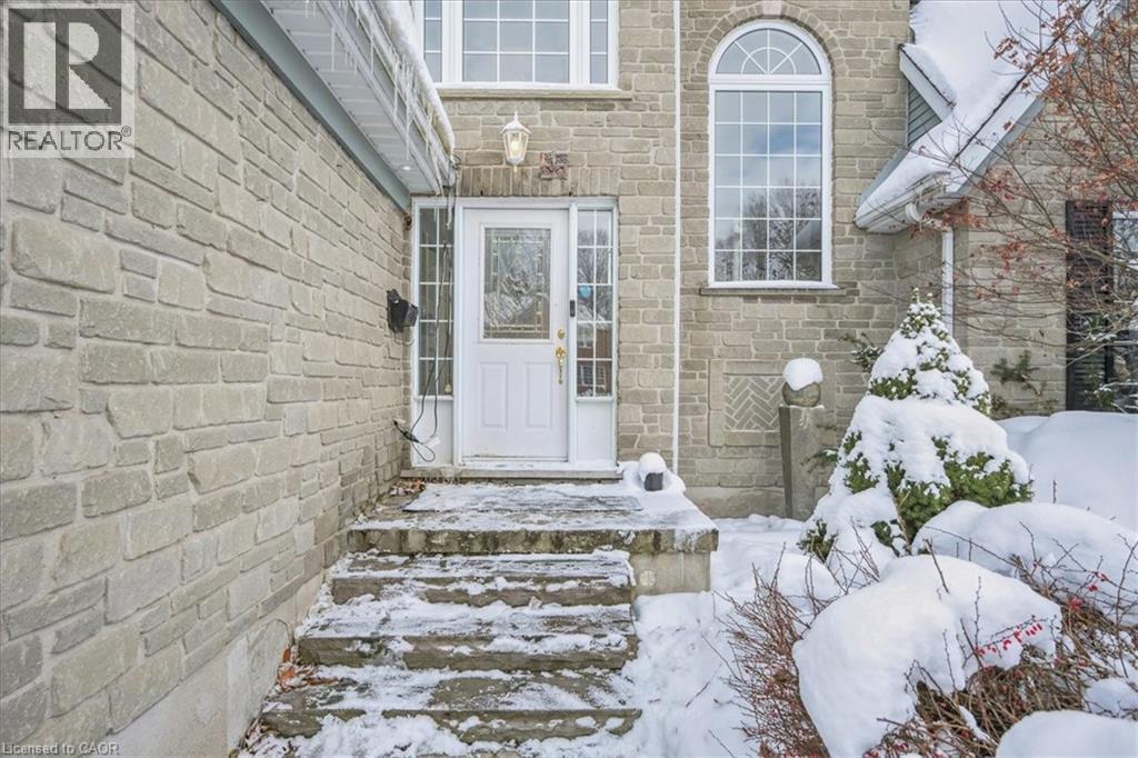 Snow covered property entrance with stone siding - 629 Burning Bush Road, Waterloo, ON - Outdoor