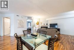 Dining space with a high end fireplace and wood finished floors -