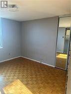 Unfurnished room featuring parquet flooring -
