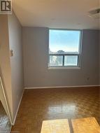 Unfurnished room with light parquet flooring -
