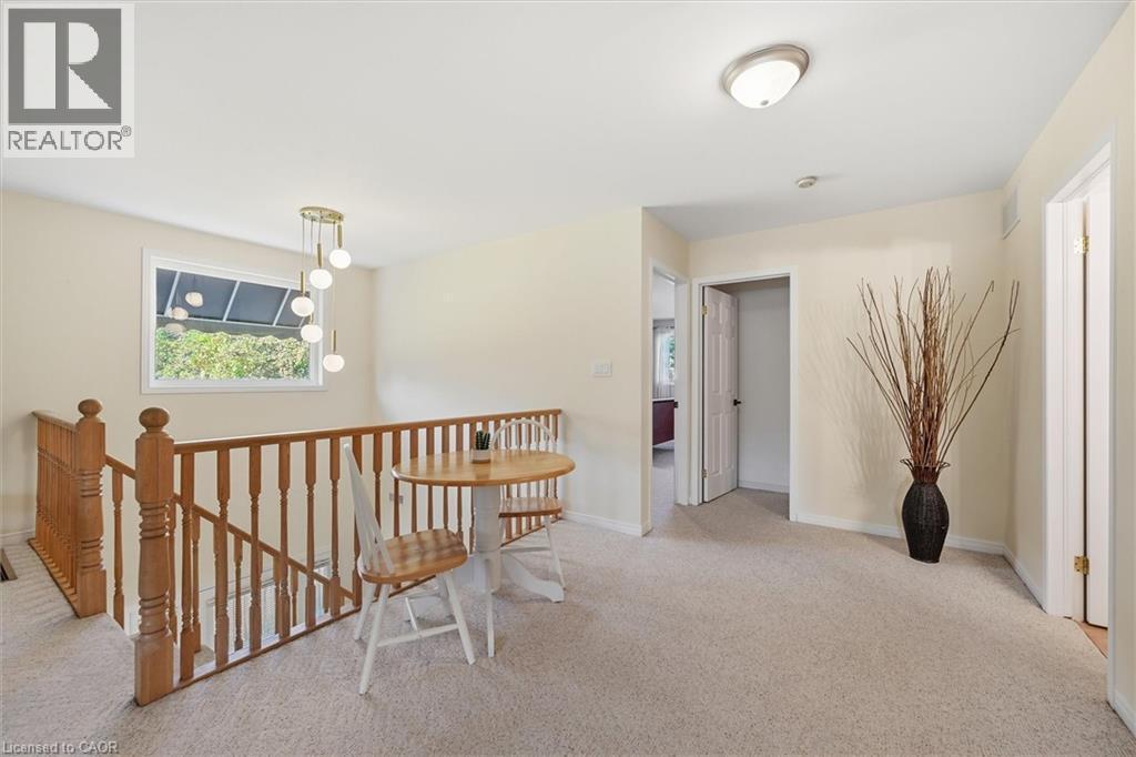 Hallway featuring light carpet and an upstairs landing - 21 Arden Avenue, Hamilton, ON - Indoor Photo Showing Other Room