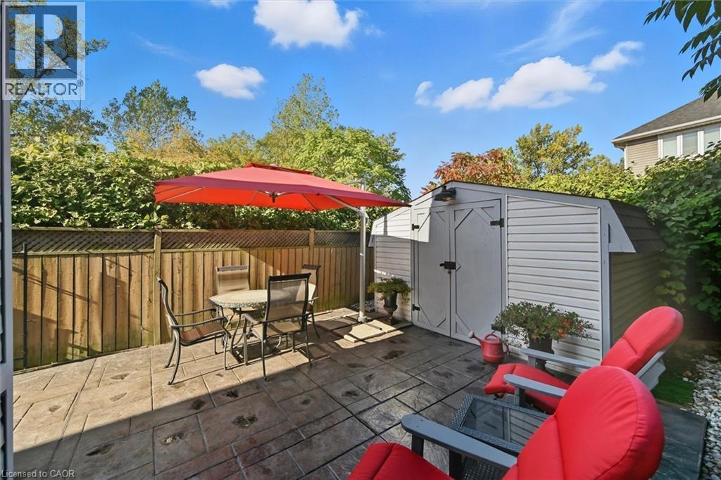 View of patio / terrace featuring a storage shed and outdoor dining area - 21 Arden Avenue, Hamilton, ON - Outdoor
