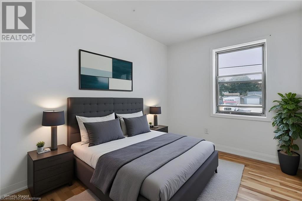 Bedroom with light wood-style flooring and baseboards - 897 Barton Street E, Hamilton, ON - Indoor Photo Showing Bedroom