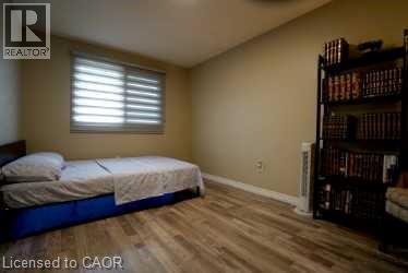 Bedroom with wood finished floors and baseboards - 147 Muriel Crescent, London, ON - Indoor Photo Showing Bedroom