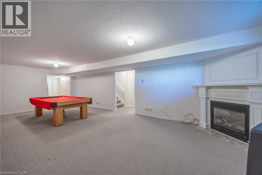 Room for gaming and even a pool table if desired. Cozy up to the gas fireplace. - 510 Queensway W Unit# 5, Simcoe, ON - Indoor Photo Showing Other Room With Fireplace