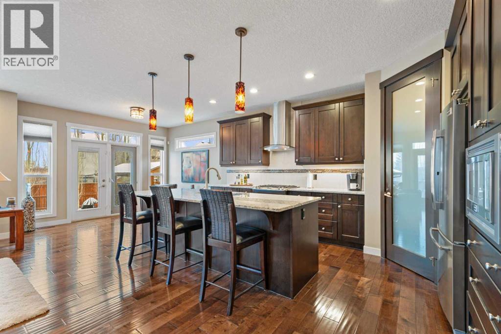 Modern kitchen with sleek finishes, ample storage, and a large island, perfect for cooking, entertaining, or gathering with family - 199 Cranarch Landing Se, Calgary, AB - Indoor