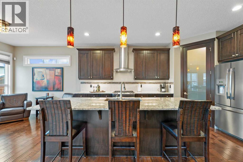 Modern kitchen with sleek finishes, ample storage, and a large island, perfect for cooking, entertaining, or gathering with family - 199 Cranarch Landing Se, Calgary, AB - Indoor Photo Showing Kitchen With Upgraded Kitchen