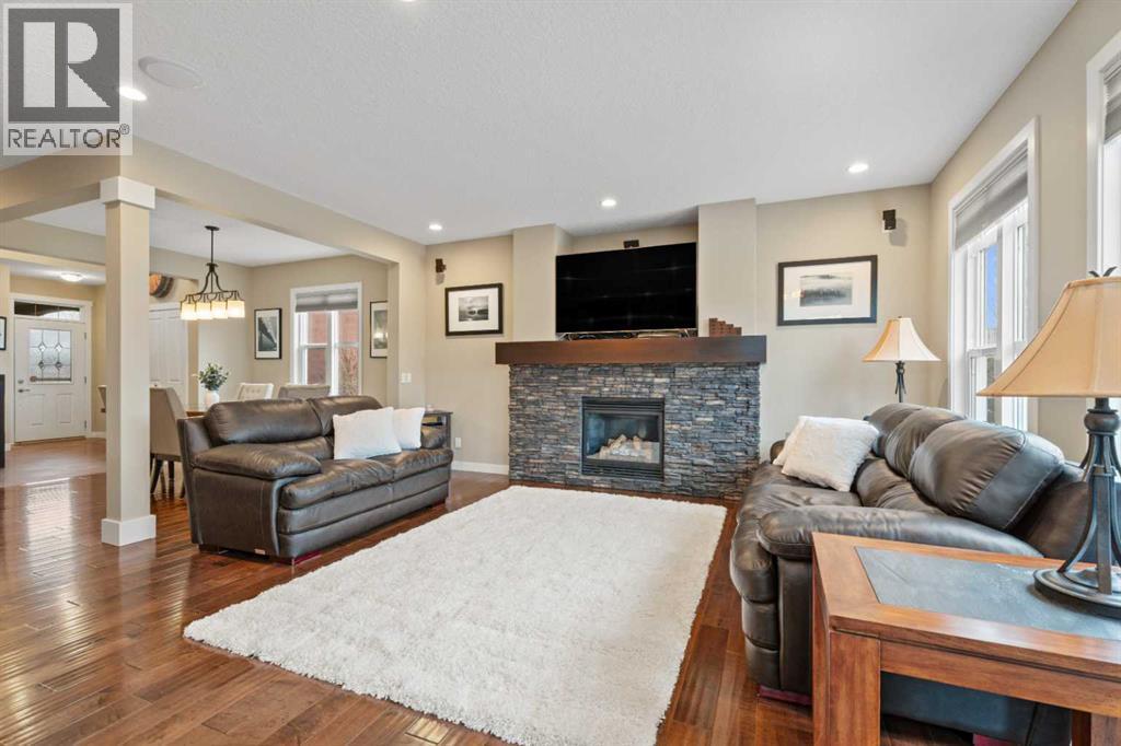 Grab your popcorn and have a movie night - 199 Cranarch Landing Se, Calgary, AB - Indoor Photo Showing Living Room With Fireplace