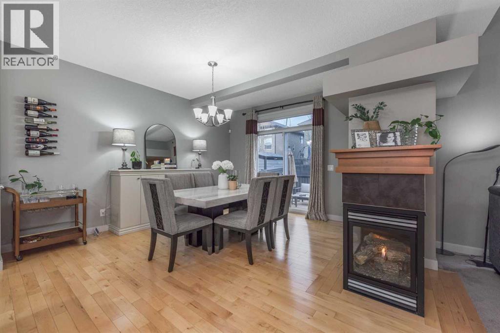76 Evanspark Circle Nw, Calgary, AB - Indoor Photo Showing Dining Room With Fireplace